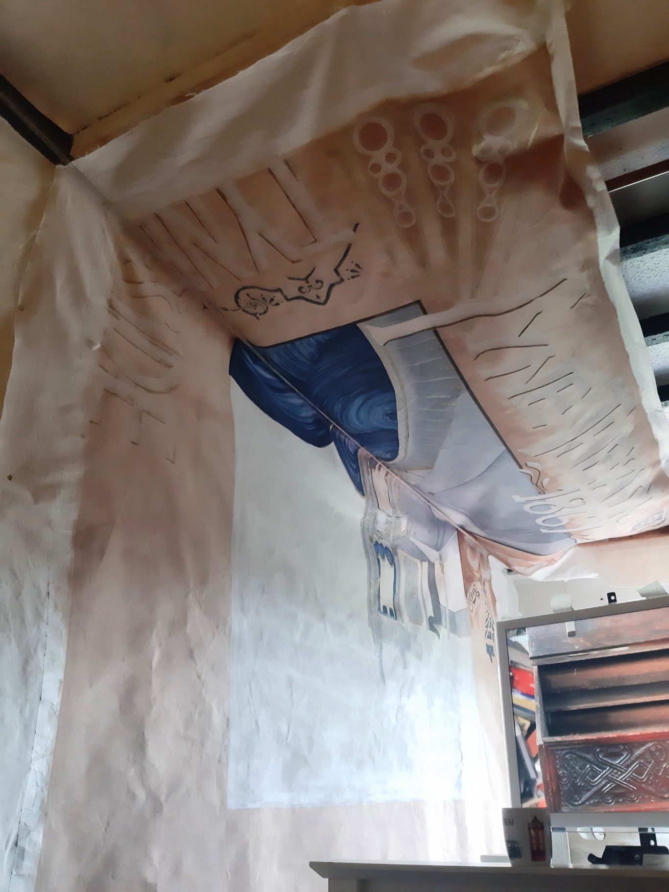 7. The top half of the canvas was then moved upwards and pinned to the ceiling beams